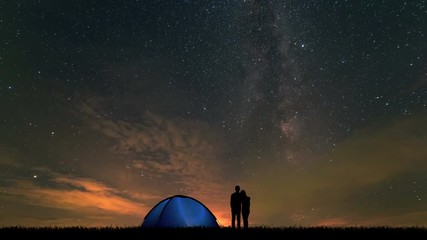 Wall Mural - The man and a woman near a camping tent standing on a cloud stream background
