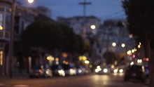 Bokeh Night Shot Of Cars Driving Down Residential Street In San Francisco