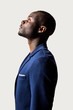 © victortorres/Stocksy - Profile portrait of young black man looking up against a white b