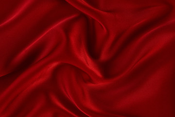 Red silk fabric background, view from above. Smooth elegant red silk or satin luxury cloth texture can use as abstract background with copy space. 