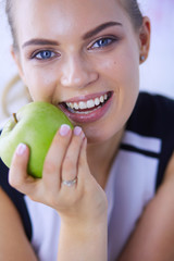 Close up portrait of healthy smiling woman with green apple.