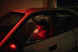 © jadiezlo/Stocksy - Woman inside of dark cark driving