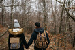 © guillefaingold/Stocksy - Amorous couple walking in cold woods