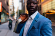 © killer/Stocksy - Young businessman walking in the street in New York City