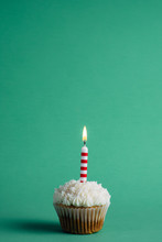 Cupcake With Birthday Candle On A Green Background