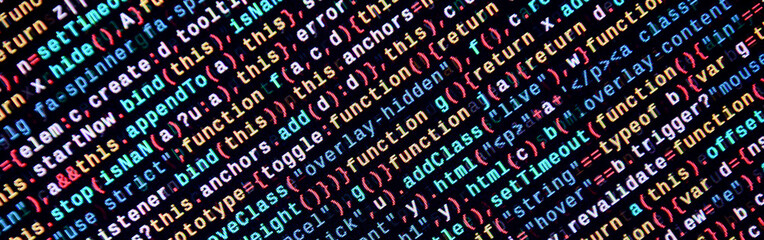 Writing programming code on laptop. Digital binary data on computer screen