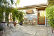 © trinettereed/Stocksy - Outdoor patio by hotel room at resort in Palm Springs, California