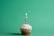 © photogabi/Stocksy - Birthday cupcake on a green background