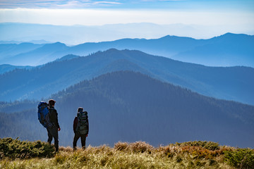 Wall Mural - the two people standing on the mountain