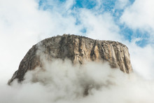 El Capitan Cliff Face Engulfed In Fog With Blue Sky Peeking Through
