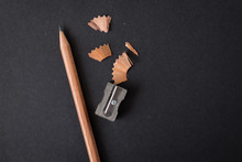 Pencil Brown Wood With Sharpening Shavings On Black Craft Paper Background.  For Concept Of Idea, Education
