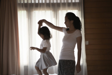 Wall Mural - portrait mother and her daughter playing at a bedroom