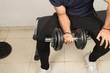 © Alberto - man exercising with dumbbells, iron bar for exercising with disks of different weights