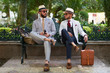© Pelle/Stocksy - Two stylish men with suits, hats and sunglasses