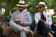 © Pelle/Stocksy - Two stylish men in a park using a tablet