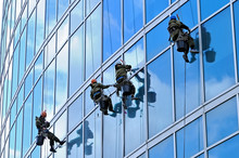 Industrial Climbers Wash Windows Of Skyscraper