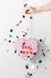 © azulclaritocasiblanco/Stocksy - cute pastel paper party heart valentine pinata behind a white wall