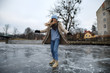 Woman in warm clothes riding skates