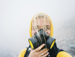© Dreamwood/Stocksy - Woman in respiratory mask posing in smoke