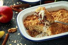 Traditional English Apple Crumble Baked In Vintage Dish And Served With Cream