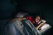 © victortorres/Stocksy - Woman Sleeping at night With Red Sleepwear