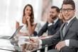 © ASDF - young businessman with his business team sitting at his Desk