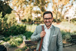 © bnenin - Portrait of a modern business man outdoors. Smiling and looking at camera.