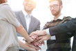 © ASDF - Business team standing joining hands together