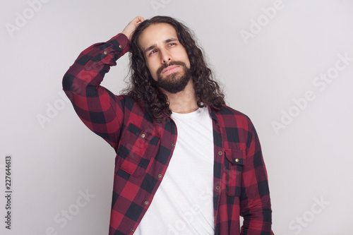 Confused Handsome Man With Beard And Black Long Curly Hair In