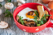 © Юлия Барычева - fried eggs with mushrooms in a pan, closeup