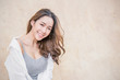 Portrait of young beautiful asian woman sit and relax over vintage wall. Smile happy asian girl looking. Lifestyle people beauty girl next door concept.