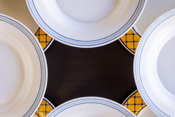 Empty Plates on Black Wooden Background