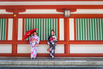 Wall Mural - Japanese women with kimono walking in Tokyo