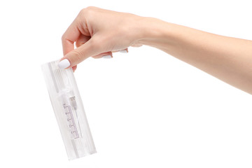 Wall Mural - Syringe in package in hand on a white background. Isolation