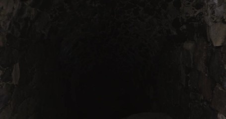 Wall Mural - Walking in a dark tunnel, in a ancient fortress, on a cold autumn day, on Suomenlinna military island, in Helsinki, Uusimaa, Finland