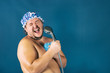 © Dmitry_Tkachev - Funny fat man in blue cap sing in the shower