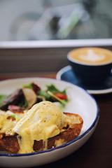 Wall Mural - Egg benedict , poached eggs with toast on wood background , English Breakfast