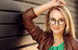 Smiling Attractive Blonde Girl With Natural Face Makeup Wearing Stylish Fashion Optical Eye Glasses. Minimalist urban clothing style, mockup for Optical Eye Glasses