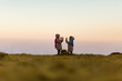 © Maya11m - Two young girls in nature, playing clapping handgame. Girls are 7 years old and are twin sisters. Dressed in pink winter coats with shawls. Beautiful blurred background. Dusk.
