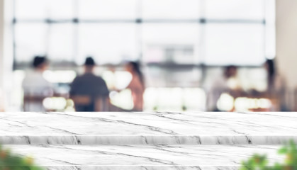 Fototapete - Empty step marble table top food stand with blur people in coffee shop background bokeh light and leaf foreground,Mock up for display or montage of product,Banner for advertise on online media