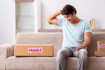 Man opening fragile parcel ordered from internet