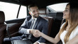 © ASDF - Handshake of business people in the back seat of a car