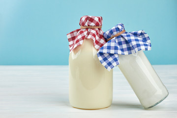 Wall Mural - Glass bottles with natural milk and yogurt. Old-fashioned bottles with healthy dairy products. Organic eating concept.