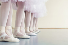 Legs Of Little Ballerinas Standing In Fifth Position