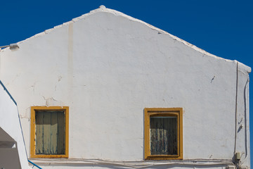 White building with yellow frames of the windows, Greece