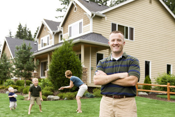 happy couple with their house in front of new house