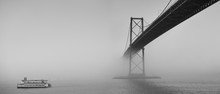 Ferry Boat Crossing Under A Suspension Bridge In Halifax, Nova Scotia In Thick Fog. 