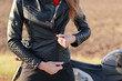 © sementsova321 - Cropped image of stylish female motorcyclist zips black leather jacket, has body protection, prepares for ride on motorbike, likes extreme and speed. Energy, transport, freedom and lifestyle