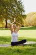 © Olesia - Girl meditates while practicing yoga outdoors in park