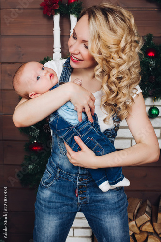 Positive Little Cute Boy With Beautiful Blonde Mom Embracing In